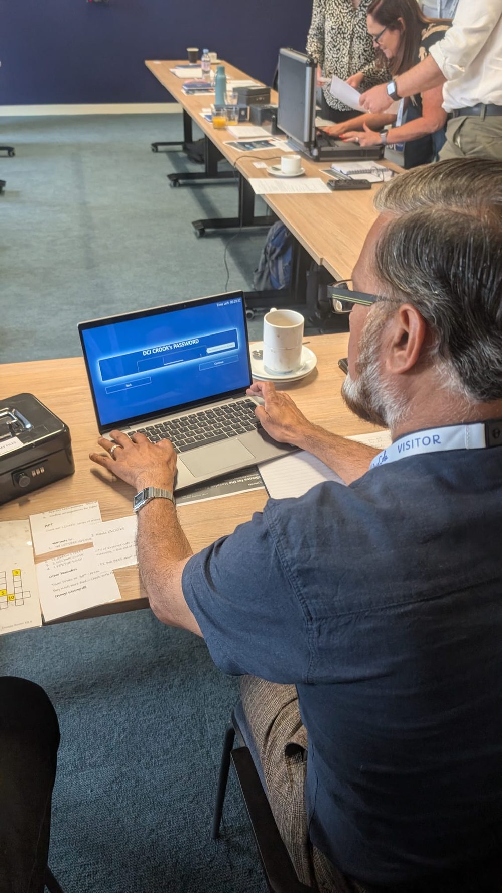 A delegate cracking a password puzzle during the simulated cyber attack exercise